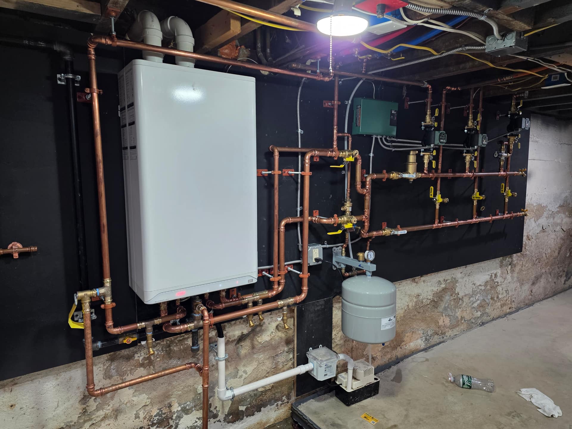 Wall-hung boiler installation with clean copper piping by Aces Highlands