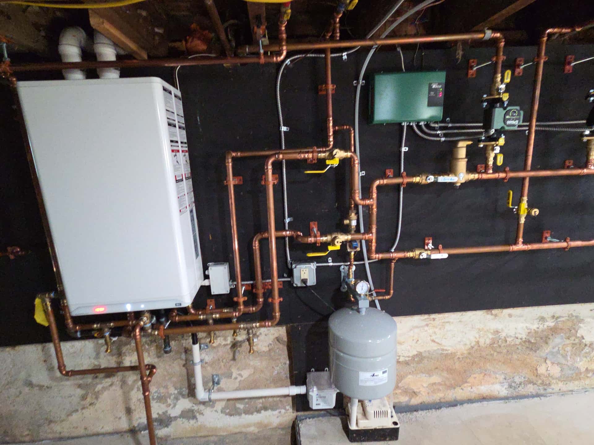 Tankless water heater and boiler installation with copper manifold by Aces Highlands