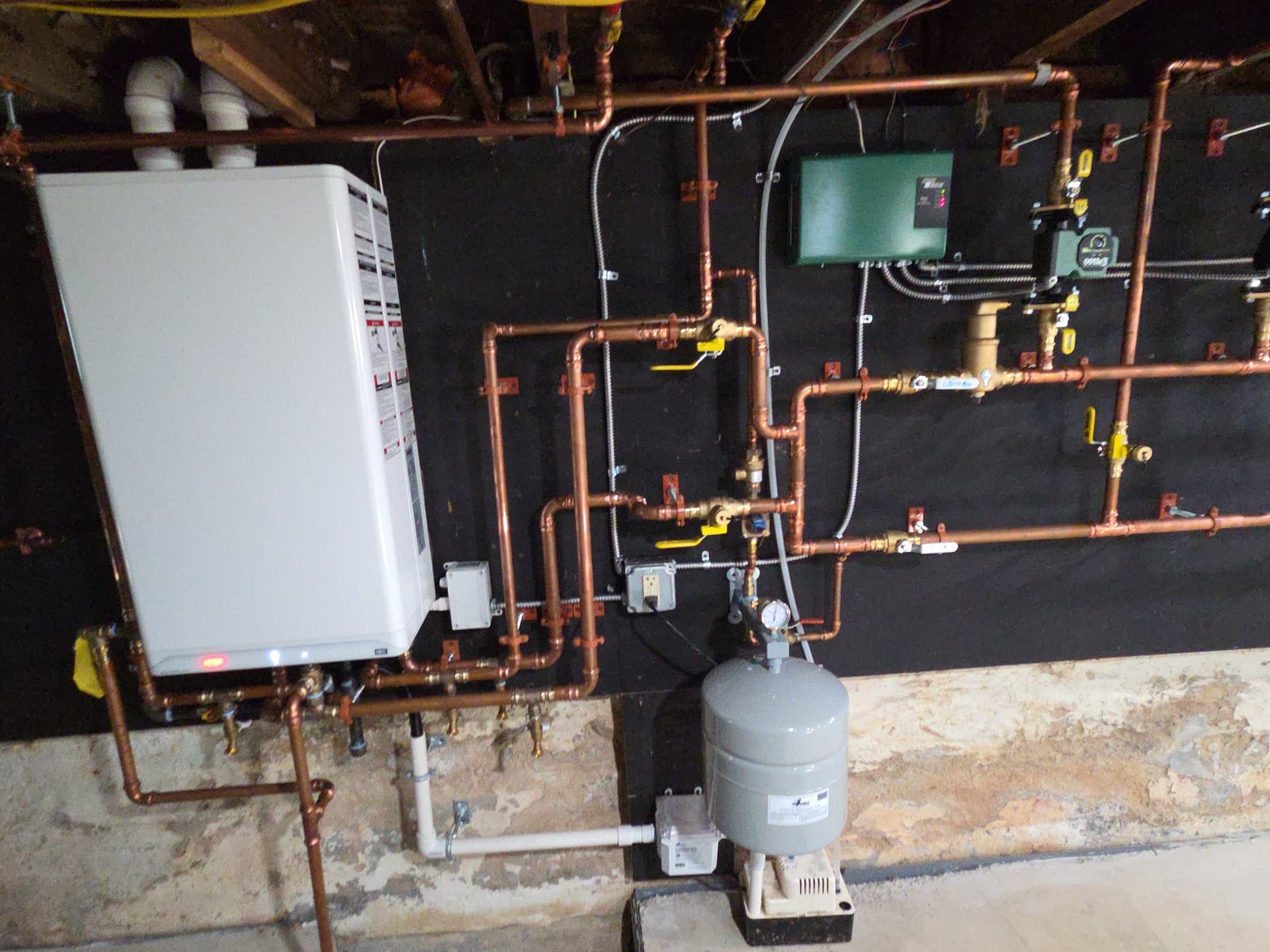 Tankless water heater and boiler installation with copper manifold by Aces Highlands